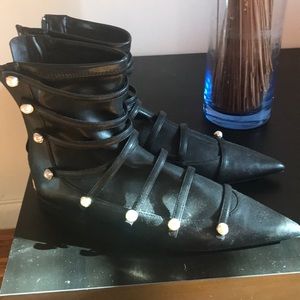 Black ankle booties with white pearls on them